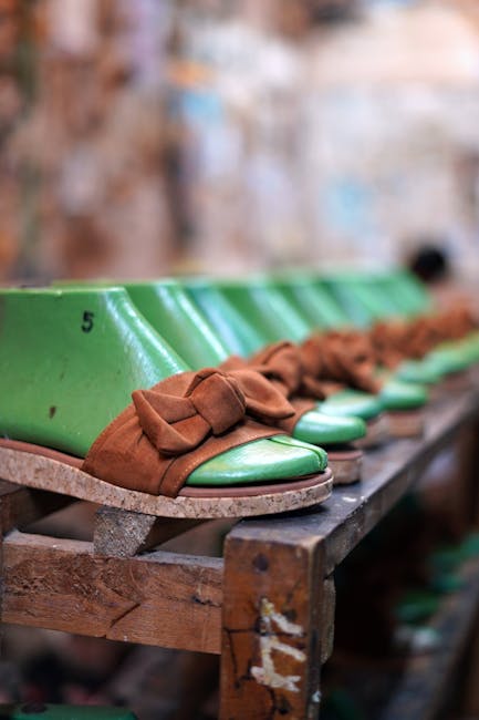 Vibrant green and brown shoes lined up in a Ticul shoemaking workshop.