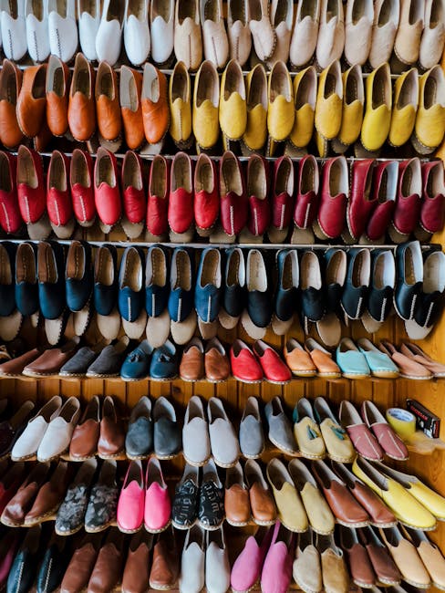 Vibrant collection of handmade leather shoes elegantly displayed on shelves in a retail store.