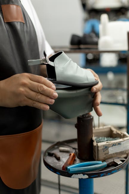 A shoemaker carefully crafting a shoe in a workshop setting, showcasing artisan skills.